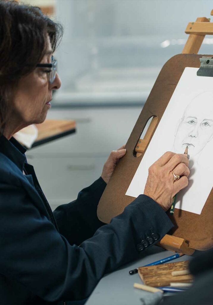 Forensic artist sketching a subject
